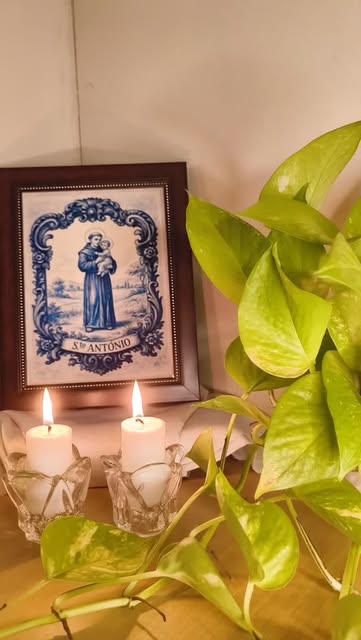 Framed blue tile artwork styled with greenery and candles